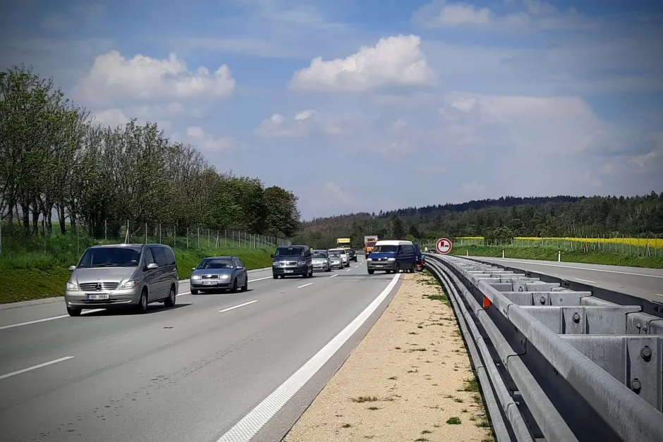Práce u dálnice za provozu za svodidlem